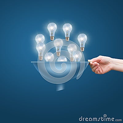 Hand with a funnel and a lot of bulbs, the concept of lots of business ideas Stock Photo