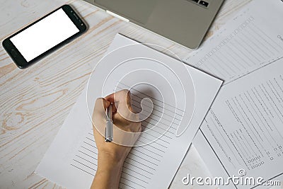 Hand of the girl writing on the blank list of paper with bunch of documents and smartphone with blank screen for your text lying Cartoon Illustration