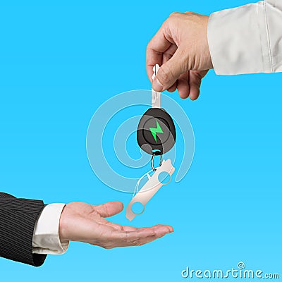 Hand give electric car key sports car sheet metal keyring Stock Photo