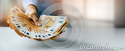 Hand gives euro money banknotes. bank credit, consumer loan or lottery prize concept. banner Stock Photo