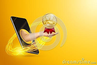 Hand gives a gold medal through the smartphone screen on a yellow background. Concept for online reward, reschedule sports, stay Stock Photo