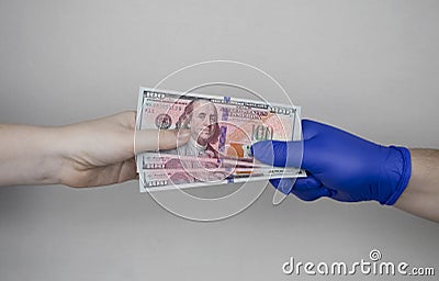 Hand in glove holds dollars with germs. The concept of dirty money as a carrier of bacteria and viruses Stock Photo