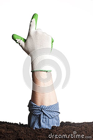 Hand going out of the ground - pointing Stock Photo