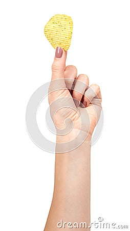 Hand with golden color potato chips, crunchy and wavy Stock Photo