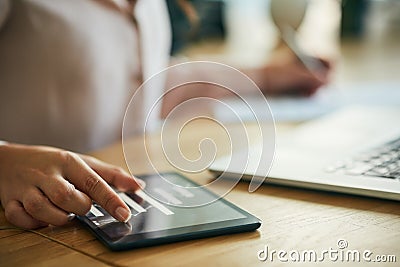Hand, graph and technology while a woman zoom in on a tablet to check the growth and development of her company. Closeup Stock Photo