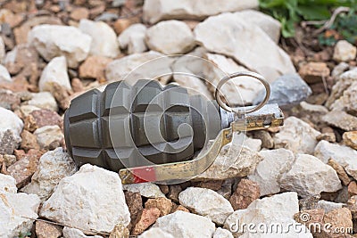 Hand grenade lying on the stones Stock Photo