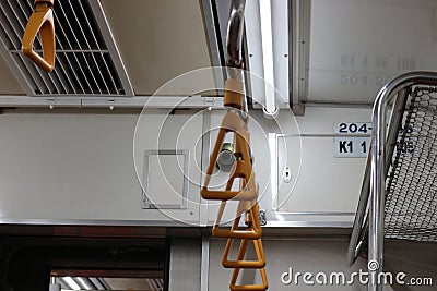 The hand handle or handgrips or handrails of commuter line passengers swaying due to the movement of the train Stock Photo