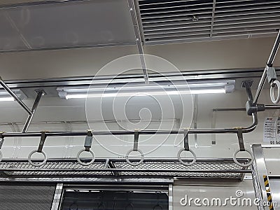 The hand handle or handgrips or handrails of commuter line passengers swaying due to the movement of the train Stock Photo