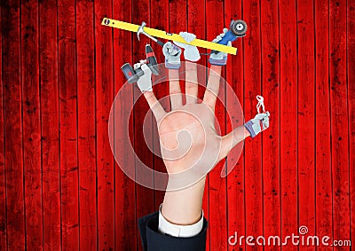 Hand with hands with tools on the fingers. Red wood background Stock Photo