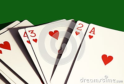 A hand of hearts only playing cards on dark green background. Stock Photo