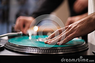 Hand of hip hop dj scratching vinyl record on turntables. Professional disc jockey scratches records on party in night club on Stock Photo