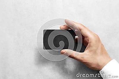 Hand hold blank black craft card mockup with rounded corners Stock Photo