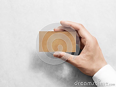 Hand hold blank plain kraft business card design mockup. Stock Photo