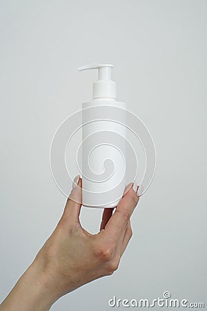 Hand hold blank white tube mock up isolated. Empty cream bottle mockup Stock Photo