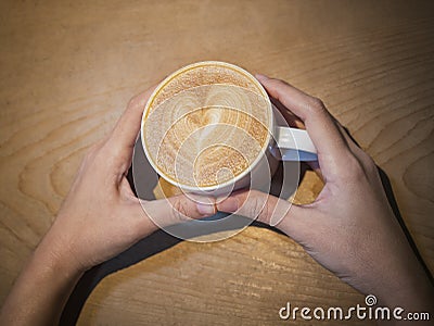 Hand hold Coffee cup on table Cafe menu Stock Photo