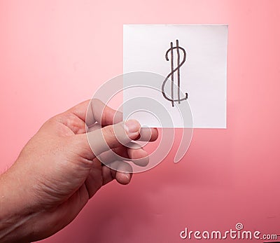 Hand hold dollar sigh on pink background Stock Photo