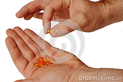 Hand hold a handful of pills, isolated on a white background Stock Photo