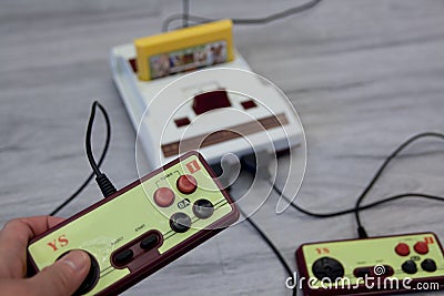 The hand hold hori controller with old Nintendo entertainment system family computer on the wooden floor in Taiwan. February 18, 2 Editorial Stock Photo
