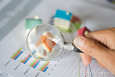 Hand hold a magnifying glass searching for a new home, Loan for real estate or save money for buy a house to family in the future Stock Photo