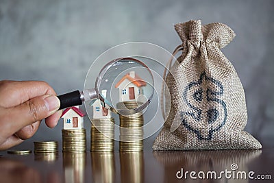 Hand hold a magnifying glass searching for a new home, Loan for real estate or save money for buy a house to family in the future Stock Photo