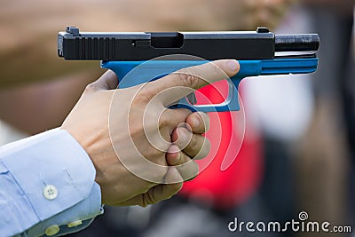 Hand hold pistol and slide back Stock Photo