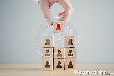 Hand hold red people icon on cube. recruiter complete team by one leader person concept. Stock Photo