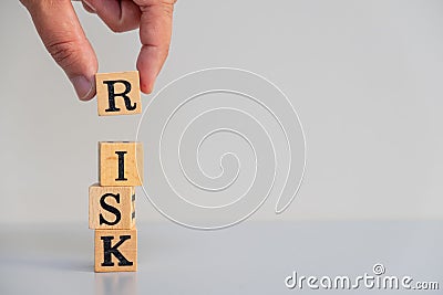 Hand hold wooden cubes with risk word on table Stock Photo