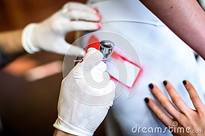 Hand holding air brush in body painting woman body. Stock Photo