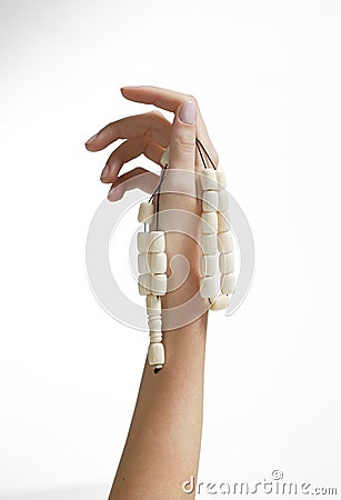 Hand holding bead string Stock Photo