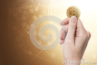 Hand holding a Bitcoin Cash coin on a bright background with blockchain network. Copy space included. Stock Photo