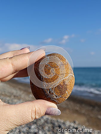 A hand holding a bizarre stone. Stock Photo