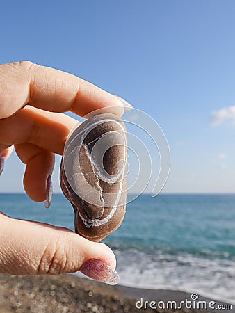 A hand holding a bizarre stone. Stock Photo