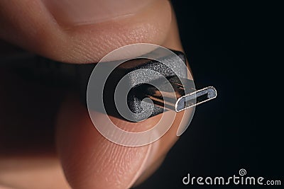Hand holding black micro USB cable. Man's hand holds a USB micro Connector. Stock Photo