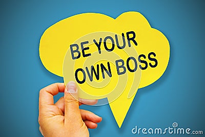 Hand holding black paper speech bubble with BE YOUR BOSS concept, over blue background, . Business Concept. Stock Photo