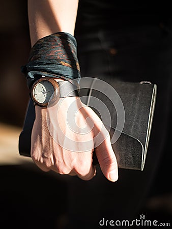 Hand holding scetchbook cover with watch Stock Photo