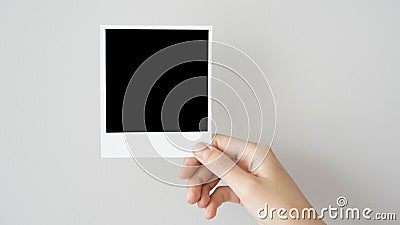 Hand holding blank photo frame Stock Photo