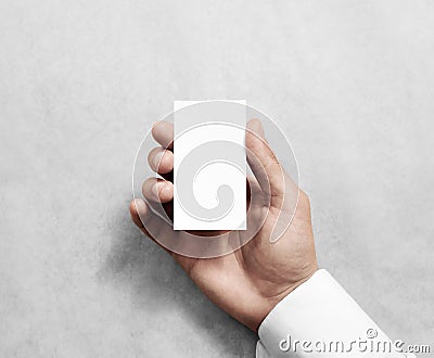 Hand holding blank vertical white business namecard mock up. Stock Photo