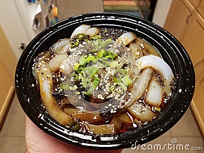 Hand holding bowl of Chinese bean starch noodles Stock Photo