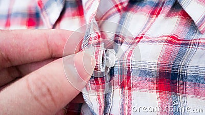 Hand holding button loincloth shirt Stock Photo