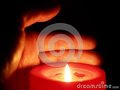 Hand holding a candle Stock Photo