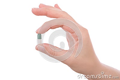 Hand holding a capsule or pill Stock Photo