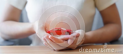 Hand holding Car toy. Vehicle insurance, warranty, Automobile rental, Transportation, Maintenance and repair concept Stock Photo