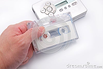 Hand Holding Cassette Tape with Cassette Player Background Stock Photo