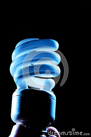 Hand holding cfl blue light-bulb lamp Stock Photo