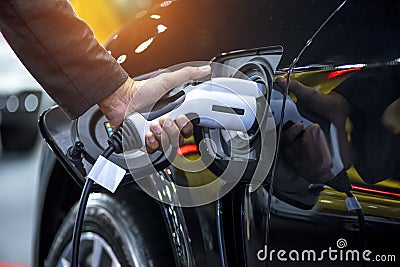 Hand holding charging electric car battery Stock Photo
