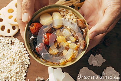 Hand holding with Ching bo leung in bowl Stock Photo
