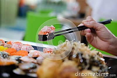 hand holding chopstick to eat sushi Stock Photo