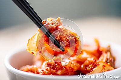 Hand holding chopsticks for eating kimchi cabbage Stock Photo