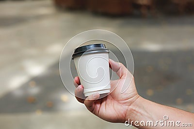 Hand holding coffee to take away Stock Photo