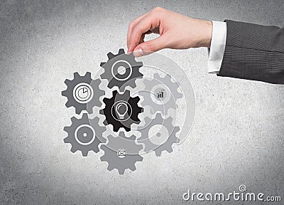 Hand holding cogwheel Stock Photo